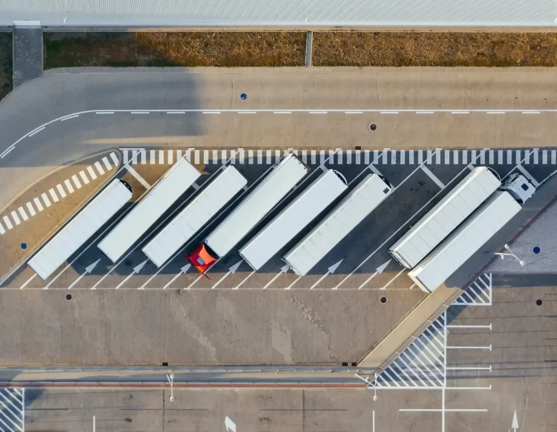Aerial view of a line of white semi trucks